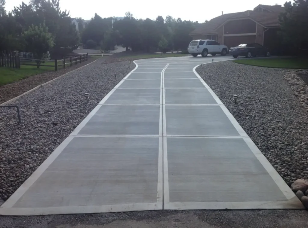 A modern concrete driveway by Northland Concrete Services, finished to perfection with clean lines and smooth surfaces.