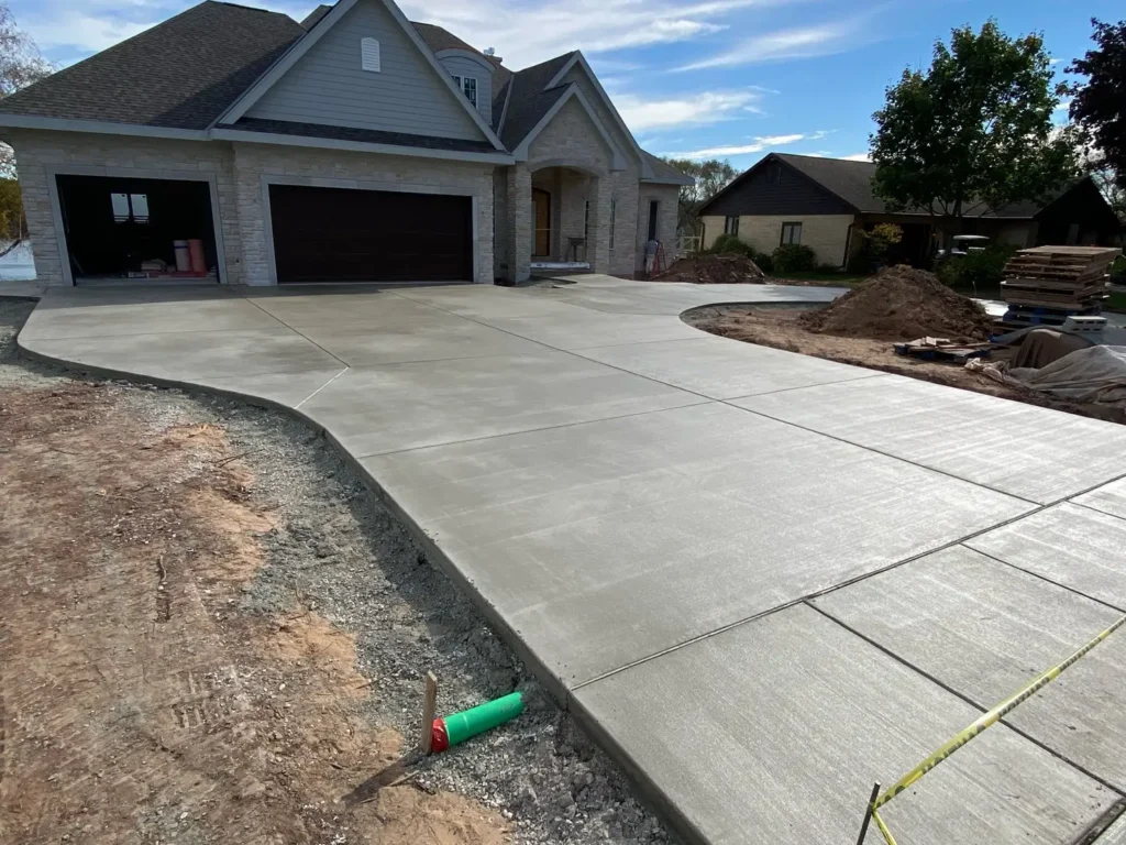 A newly installed concrete driveways by Northland Concrete Services, featuring a sleek and modern finish.