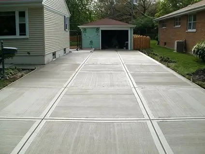 A spacious residential concrete driveway by Northland Concrete Services, complementing the home's modern exterior.