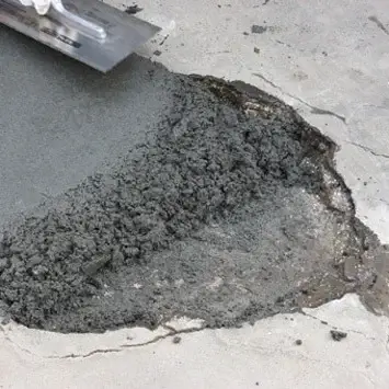 Northland Concrete Services is executing concrete relaying at a garage entryway, improving its structural integrity.