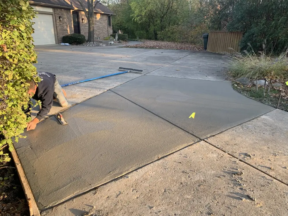 Northland Concrete Services is performing concrete relaying on a sidewalk with expert precision, creating a smooth and level surface.